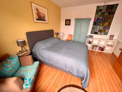 a bedroom with a bed and a couch at City room in Alkmaar