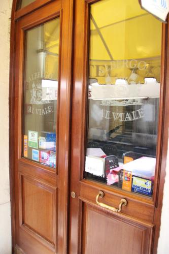 a wooden cabinet with a glass door with food inside at Albergo Al Viale in Trieste