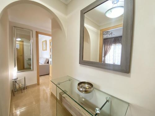 a bathroom with a glass counter and a mirror at Porto Azul 2 in Calpe