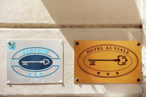 two signs on a wall that reads hotel all wake at Albergo Al Viale in Trieste