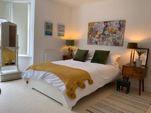 a bedroom with a large white bed with green pillows at Boutique City Centre Home in Chichester