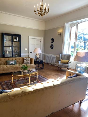 a living room with a couch and a table at Reymerston Hall in Norwich