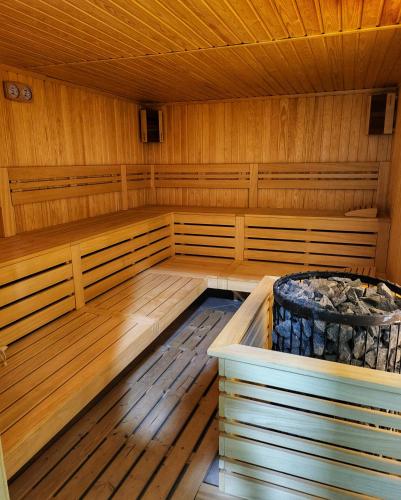 a large wooden sauna with a tub in it at Elegantz Apartments LaMer in Varna City