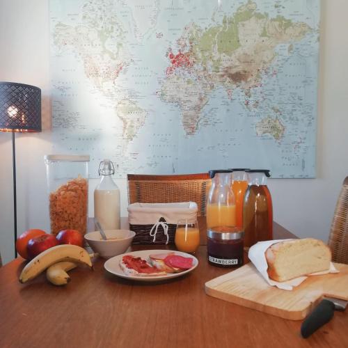 a table with a plate of breakfast foods and juice at Grótta Northern Lights - Apartment & Rooms in Reykjavík