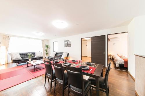 a dining room and living room with a table and chairs at come-on inn OSAKA in Osaka