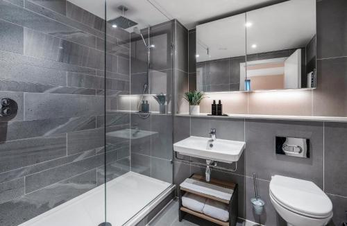 a bathroom with a shower toilet and a sink at CitySuites 2 Aparthotel in Manchester