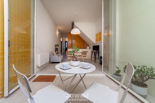 a living room with a white table and chairs at Casinhas da Beira Mar by Home Sweet Home Aveiro in Aveiro