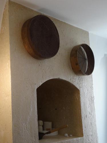 a wall with three wooden plates on it at LA DIMORA DELLE 3 ZIE in Matera