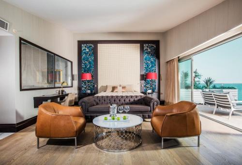 
a living room filled with furniture and a dog at Charisma De Luxe Hotel in Kuşadası
