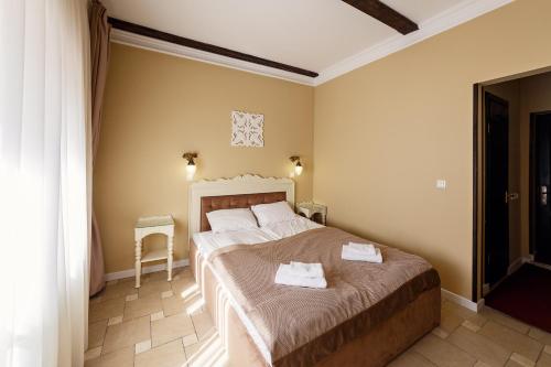 a bedroom with two beds with towels on them at Patkovski in Bukovel