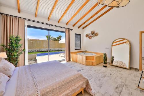 a bedroom with a bed and a tub and a mirror at Golden Lighthouse Hotel in Patara
