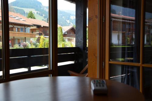 a remote control sitting on a table in front of a window at Nebelhorn Relaxhotel in Obermaiselstein
