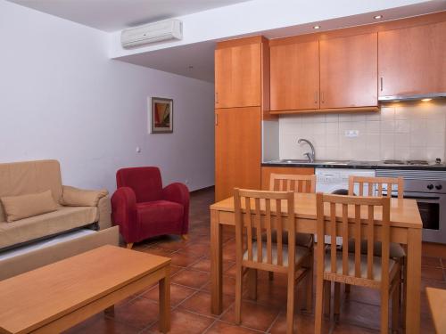 a kitchen and a living room with a table and chairs at VitaSol Park in Lagos