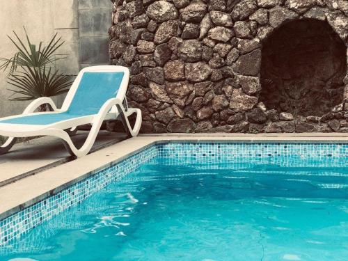 a chair sitting next to a swimming pool at Red castle in Yerevan