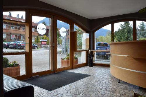 a room with large windows with a view of a street at Nebelhorn Relaxhotel in Obermaiselstein