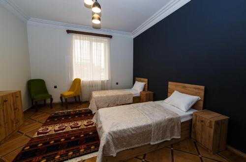 a room with two beds and a window at Red castle in Yerevan