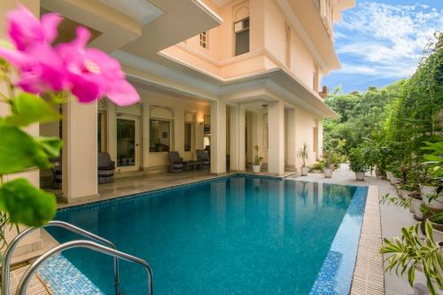 a swimming pool in a villa with a house at Akshay Niwas Boutique Luxury Hotel in Udaipur