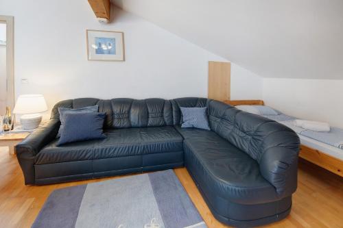 a black leather couch in a living room at Haus Lowe Appartement 2 Stock Nr 4 in Filzmoos