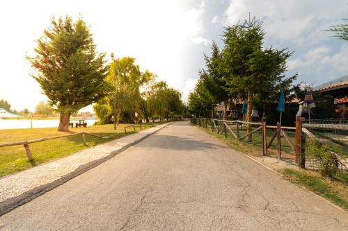 an empty street with trees and a fence at Parco Del Sangro in Castel di Sangro