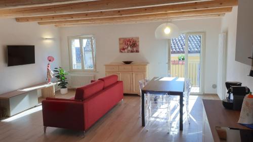 a living room with a red couch and a table at Aghèl Luxury Room in Recanati