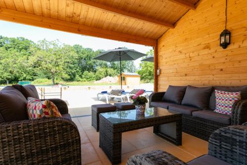 un salon avec des canapés et une table dans l'établissement Luxury 3 Bed Home with Heated Swimming Pool Air Con and Boules Pitch, à Salignac