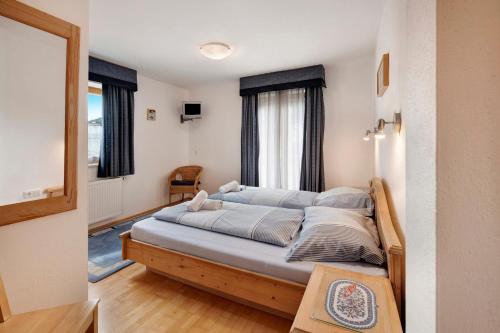 a bedroom with a large bed in front of a window at Haus Lowe Appartement 1 Stock Nr 2 in Filzmoos