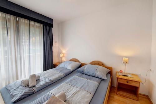 two beds in a bedroom with a window at Haus Lowe Appartement 1 Stock Nr 2 in Filzmoos