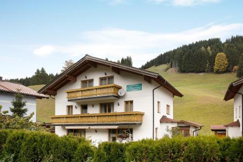 a large white building with wooden balconies on it at Haus Lowe Appartement 1 Stock Nr 2 in Filzmoos