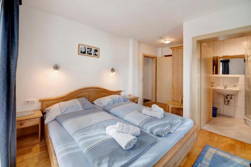 a bedroom with a bed with towels on it at Haus Lowe Appartement 1 Stock Nr 2 in Filzmoos