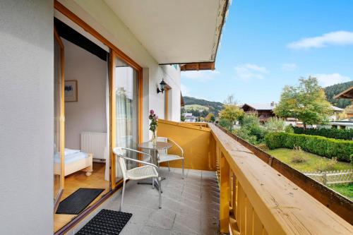 a balcony with a table and chairs and a view at Haus Lowe Appartement 1 Stock Nr 2 in Filzmoos