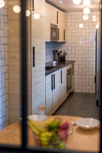 a kitchen with a table with a bowl of food at Eklo Hotels Le Havre in Le Havre