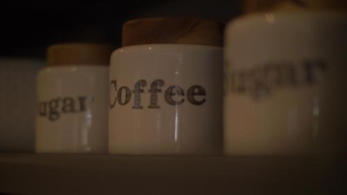 a group of coffee cups sitting on a shelf at Van der Valk Hotel Le Catalogne Saint Aygulf in Saint-Aygulf