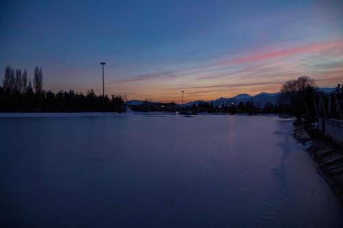 a large body of water with a sunset in the background at Parco Del Sangro in Castel di Sangro