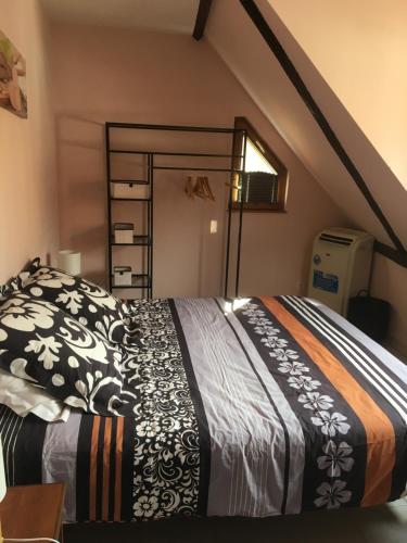 a bedroom with a bed in a attic at Gîte "Smart'In" in Eguisheim