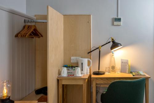 a room with a desk with a chair and a lamp at The Royal Foundation of St Katharine in London