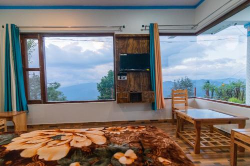 アルモラにあるKasar wonder hill homestayの大きな窓、バスタブ、ベッドが備わる客室です。