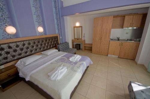 a bedroom with a bed with white towels on it at Blue Sea Beach Resort in Skala Potamias