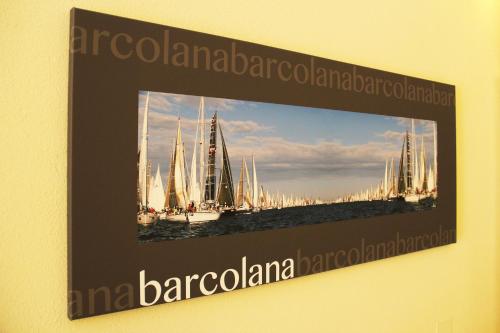 a framed picture of a group of sailboats on the water at Albergo Al Viale in Trieste