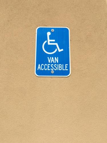 a blue sign that says van accessible on a wall at Rodeway Inn & Suites in Winnfield