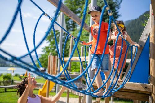 a group of children playing on a playground at Familien- Sportresort BRENNSEEHOF in Feld am See
