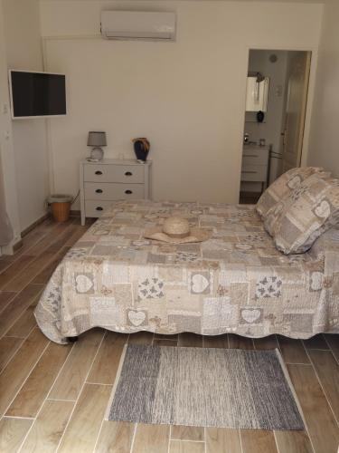 a bedroom with a large bed and a dresser at Le Jardin des Selves in Draguignan