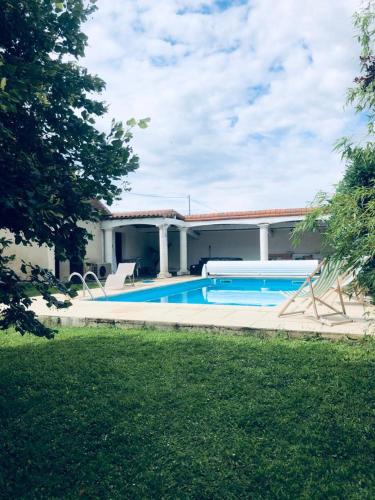 a house with a swimming pool in front of it at Quinta in Argy