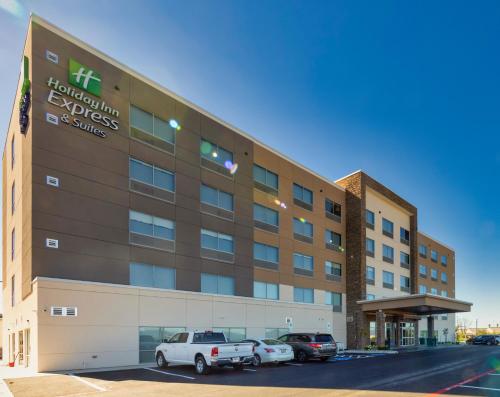 an office building with cars parked in a parking lot at Holiday Inn Express & Suites - Harrisonburg University Area by IHG in Harrisonburg