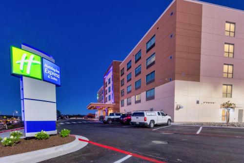 a hotel with cars parked in front of a building at Holiday Inn Express & Suites - Harrisonburg University Area by IHG in Harrisonburg