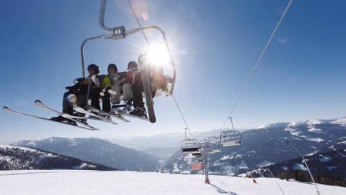 a group of people riding on a ski lift at Familien- Sportresort BRENNSEEHOF in Feld am See