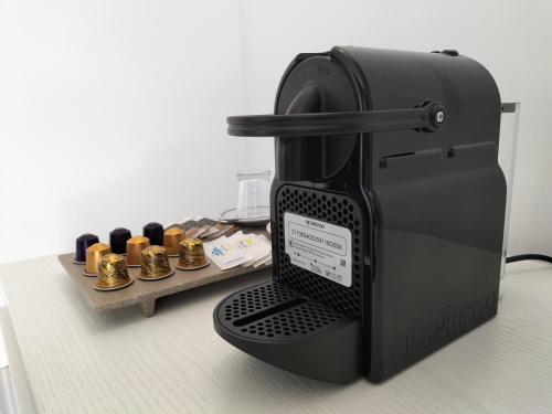 a black coffee maker is sitting on a counter at Hotel Avenida in Benidorm