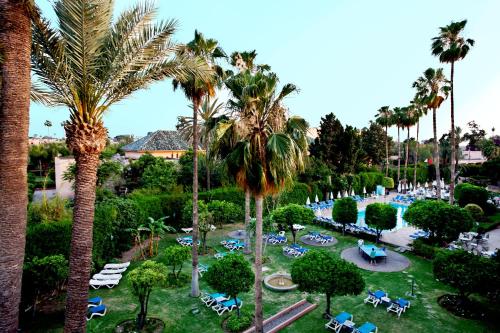 an aerial view of a resort with palm trees at Chems Hotel in Marrakech