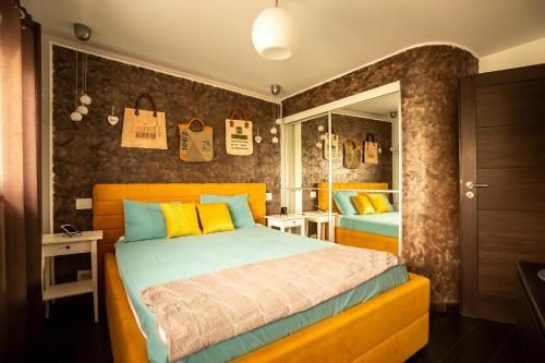 a bedroom with a large bed and a mirror at Amo Bucharest in Bucharest