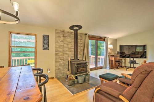 a living room with a wooden table and a wood stove at Port Jervis Home about 8 Acres with Mountain View! in Port Jervis