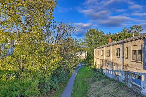 a path next to an old building and trees at Newly Renovated Penn Yan Apartment Less Than 1 Mi to Lake! in Penn Yan